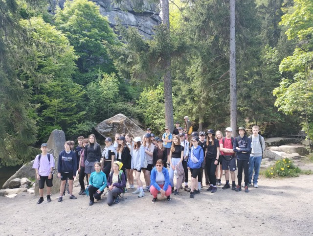 Uczniowie i nauczyciele na wycieczce w górach.